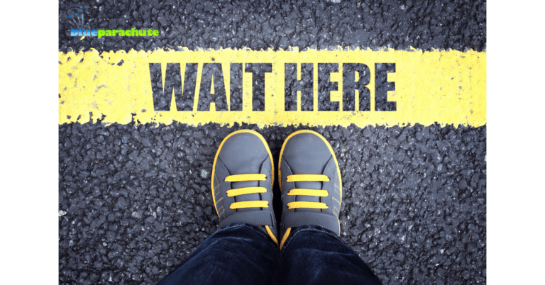 The ground has the words WAIT HERE painted in yellow, and a child's shoes are touching the bottom of the words. This indicates someone is using how to teach patience to get the child to wait.