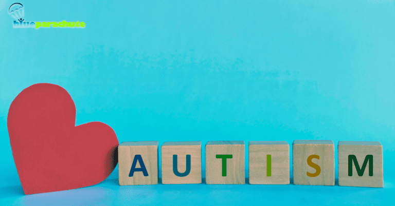 A blue background with a red heart and six wooden blocks spelling out the word autism. Each letter of the word is a different color. This indicates the article will discuss recognizing autism.