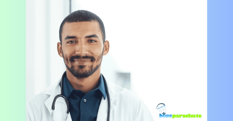 A male doctor with short brown hair, a mustache, and a short beard is smiling at the camera. He is showing that life can be very good after an autism diagnosis of yourself or your loved one.